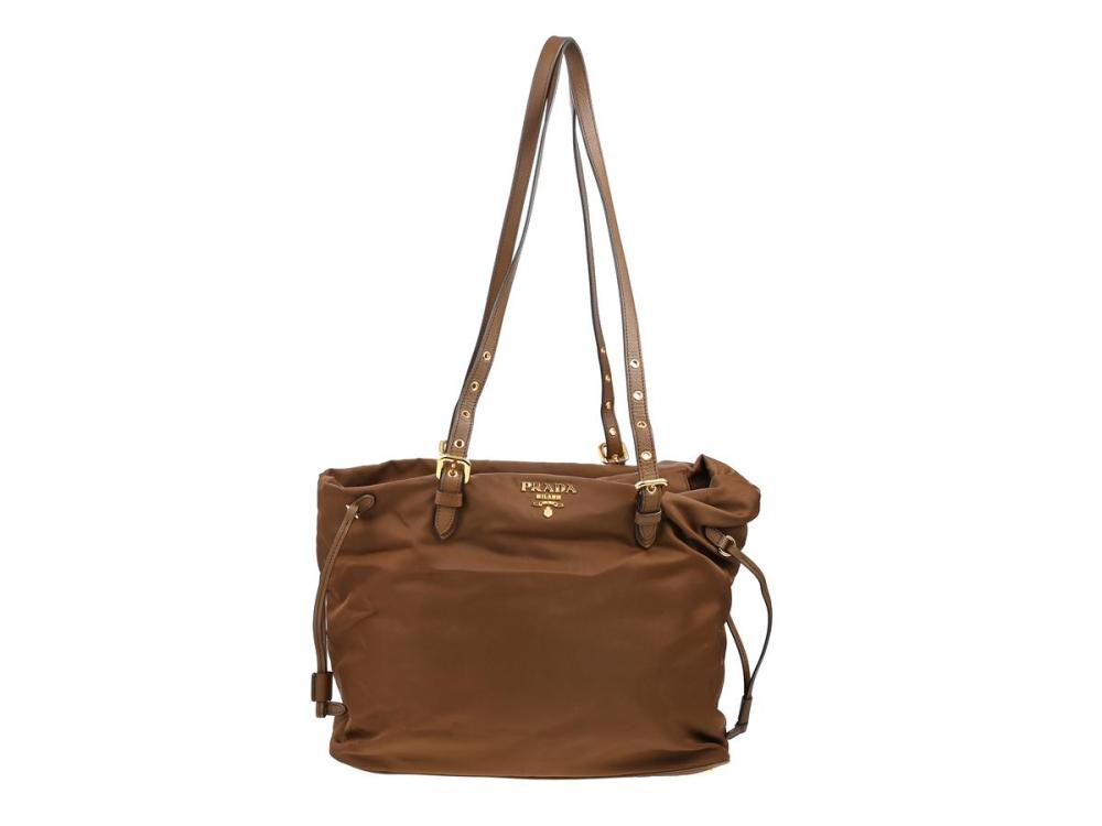 Accessories

Handbags

BAG, PRADA, Zip Shopping Tote Bag, brown nylon. brown leather, gold-tone hardware, 33,5x32x13 cm.