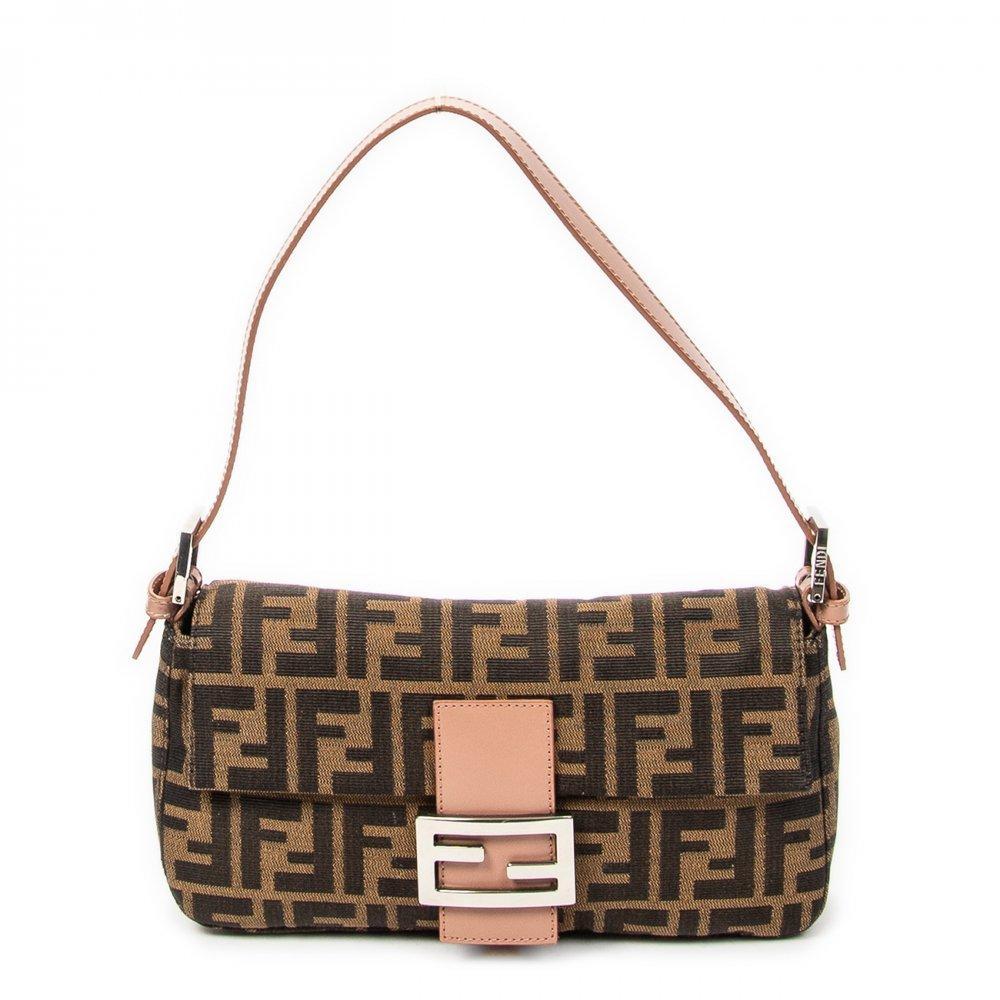 Description

FENDI
Baguette bag.
In Zucca canvas with dark and light brown logo and pink leather details. Central strap with the classic metallic double F. Silver hardware. Short buckle adjustable shoulder strap. Brown fabric interior.
With interior numbering.
In excellent condition, light signs of use.
Measurements: 26 x 14,5 x 5 cm.
The Fendi Baguette is one of the most iconic bags in the history of contemporary fashion and a key piece in Fendi’s aesthetic language. Created in 1997 by Silvia Venturini Fendi, its design marked a before and after by introducing the concept of "it bag".

With interior numbering. In excellent condition, slight signs of use.