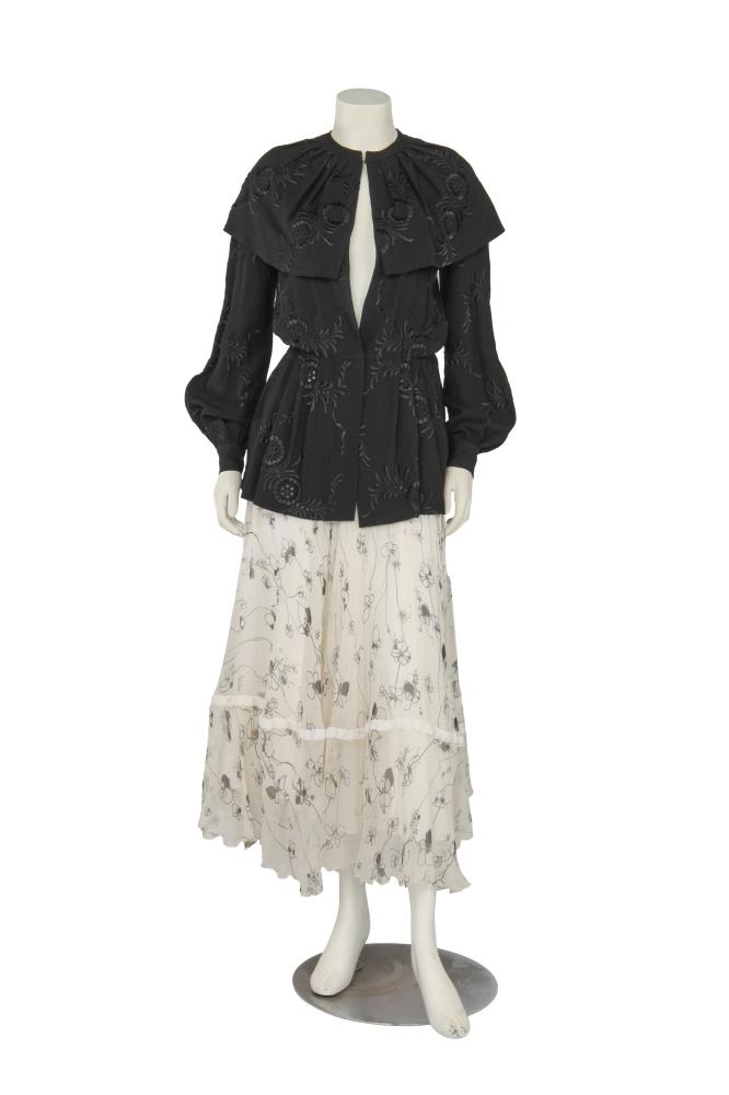 A Thea Porter embroidered jacket and ’Gypsy’ skirt, 1970s

A Thea Porter embroidered jacket and ’Gypsy’ skirt, 1970s

comprising: a black moss crêpe blouse with eyelet embroidery, with deep collar and no fastenings, Couture labelled, bust approx 91cm 36in; the white chiffon skirt printed with delicate floral trails, flounced hem edged in white velvet ribbon, unlabelled, waist 61cm 24in (2)

Share this lot: