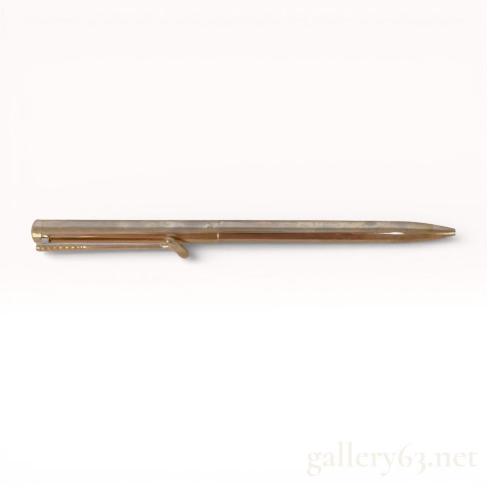 Description
Tiffany and Co. ballpoint pen designed by Paloma Picasso, late 20th century. Constructed from yellow gold-toned metal, the pen features the signature X or Kiss clip design and a slim cylindrical profile. The clip is marked with Tiffany and Co. and the Paloma Picasso script signature. This lot includes the original Tiffany Blue presentation box, drawstring pouch, and care card.