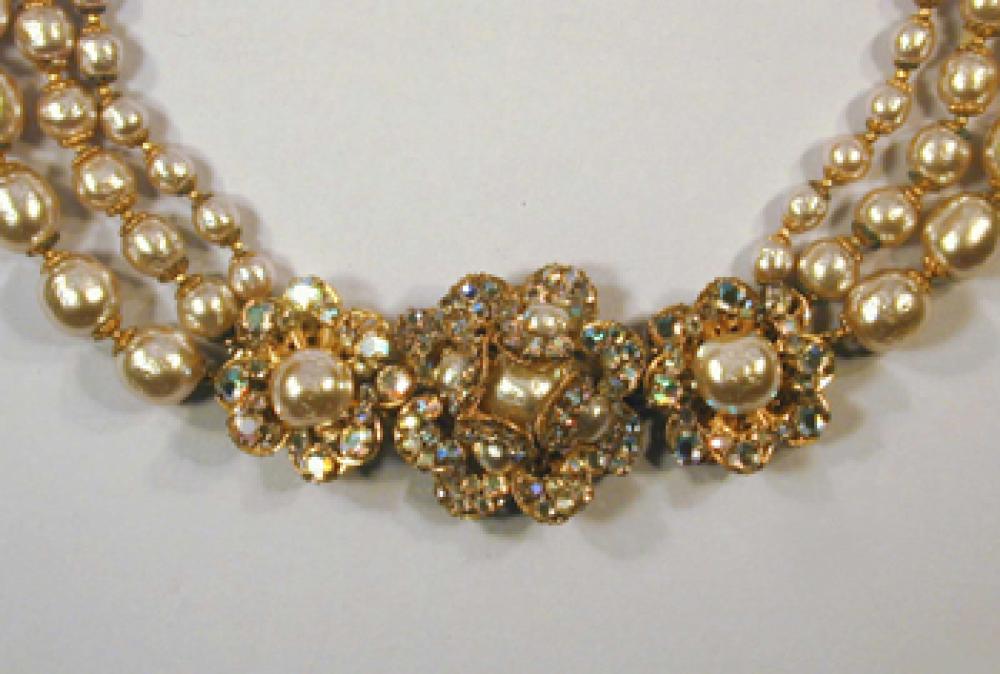 Miriam Haskell Pearl and Flower Necklace

Lot 237
Miriam Haskell Pearl and Flower Necklace
 Three stands of gold tone pearls with three rhinestone flower clusters.