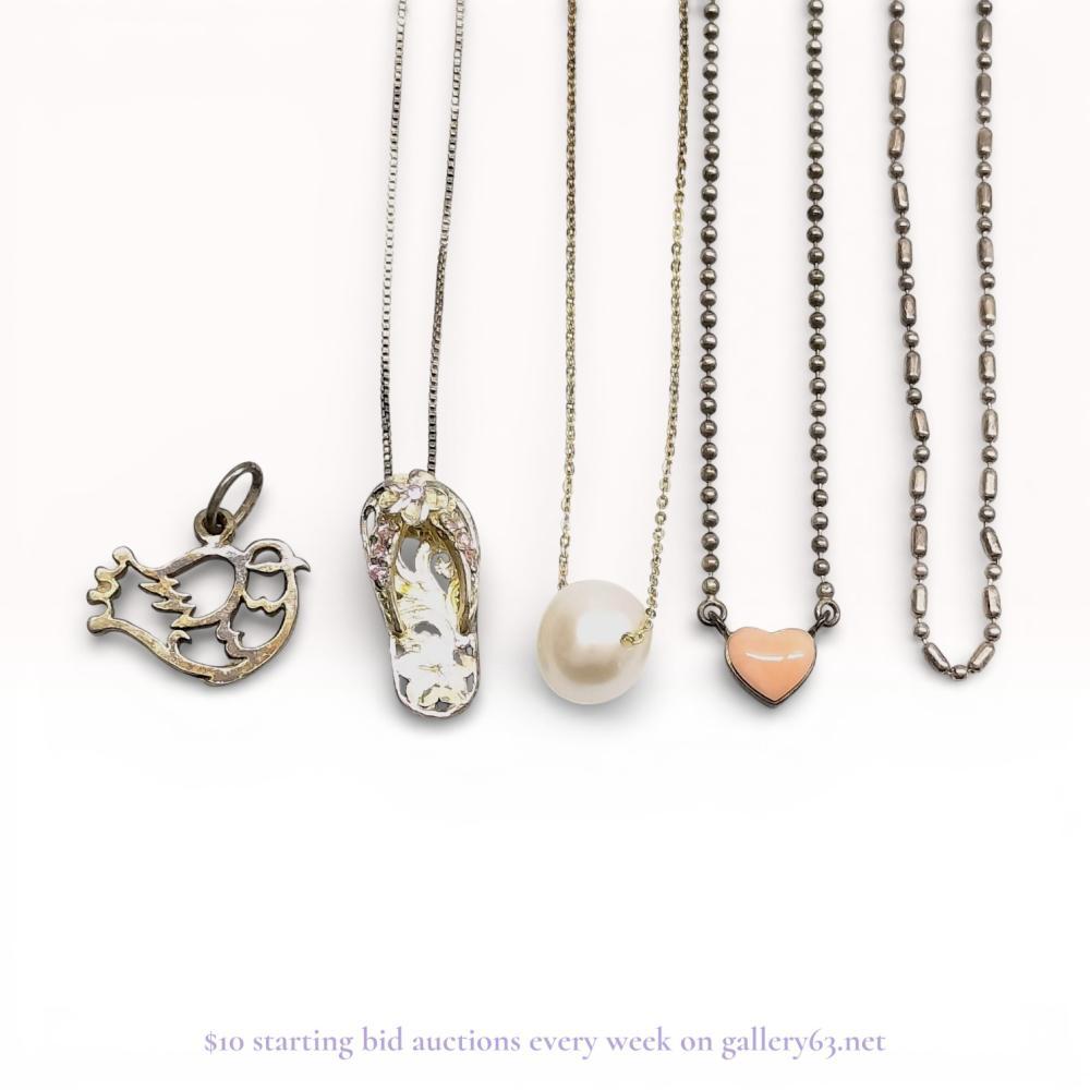 Description
A group of sterling silver and vermeil jewelry items, including pendant necklaces and charms, contemporary. The collection features a 10-12mm floating pearl on an adjustable cable chain, a stone-set flip-flop pendant on a box chain, and a pink heart pendant on a ball chain. Additional pieces include an openwork bird charm and an alternating bead and barrel link chain, all featuring spring ring clasps. Hallmarks including SILVER 925 and 925 SILVER are present on various rectangular and teardrop-shaped tags.