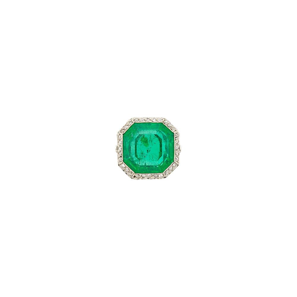 Property of a Prominent CollectorOne cut-cornered square step-cut emerald ap. 7.50 cts., small single-cut diamonds, circa 1915, ap. 4.6 dwts. Size 4 1/2.
 
With AGL report no. 1154130 stating Colombian origin, with gemological evidence of Minor Traditional clarity enhancement.

Emerald: bright medium green, moderately included, some inclusions visible, several minor surface-reaching inclusions, good transparency, lively.Lovely mounting. Width 5/8 inch.                            
Any condition statement is given as a courtesy to a client, is an opinion and should not be treated as a statement of fact and our Organization shall have no responsibility for any error or omission. Please contact the specialist department to request further information or additional images that may be available.