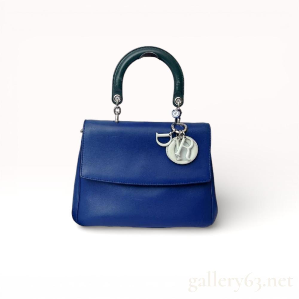 Description
Christian Dior mini Be Dior flap bag crafted in smooth tri-color leather featuring a structured silhouette. Bag having a top handle in contrasting leather and a front flap closure. Front accented with hanging silver-tone Dior letter charms. Interior featuring a compact main compartment. Finished with silver-tone hardware. Authentic Christian Dior mini bag from the 2015 Collection by Raf Simons. 2015 is trending. 
Blue Leather
Silver-Tone Hardware
Single Exterior Pocket
Leather Lining & Single Interior Pocket
Push-Lock Closure at Front
Protective Feet at Base