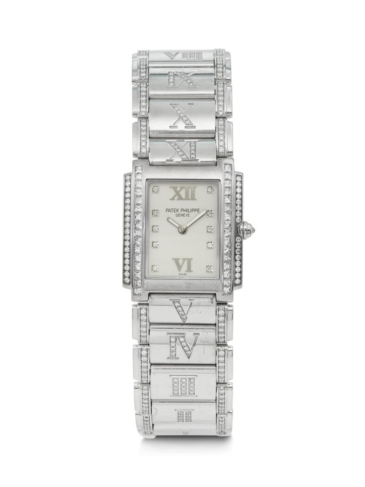 PATEK PHILIPPE, DAZZLING AND RARE 18K WHITE GOLD AND DIAMOND SET ‘TWENTY~4’ WITH DIAMOND BRACELET, REF. 4910/41G

CIRCA: 2000s 
MOVEMENT NO: 16’733’862 
CASE NO: 4’162’318 
CASE MATERIAL: 18k white gold and diamond-set 
CASE DIAMETER: 25 x 30 mm. 
BRACELET MATERIAL: 18k white gold and diamond-set 
BRACELET SIZE: Approx. 175 mm. overall length 
DIAL: Silvered with diamond indexes 
MOVEMENT: Quartz 
BOX: No 
PAPERS: No