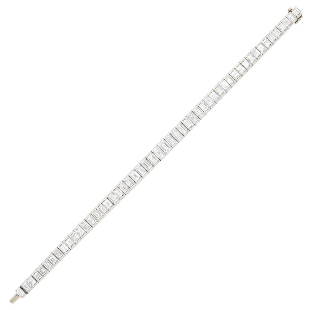 The Martin and Lynn Halbfinger Collection52 rectangular and square-cut diamonds ap. 13.25 cts., ap. 28 dwts. Length 6 3/4 inches.Sale Type: Important Jewelry

Diamonds: G-H-I-VS.Width 1/4 to 3/16 inch.                            
Any condition statement is given as a courtesy to a client, is an opinion and should not be treated as a statement of fact and our Organization shall have no responsibility for any error or omission. Please contact the specialist department to request further information or additional images that may be available.