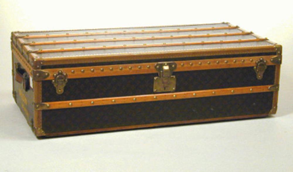 Louis Vuitton Footlocker Trunk

Lot 1246
Louis Vuitton Footlocker Trunk
 1930s 
 Monogram canvas, with LV stamped leather trim, wood bands, brass corners and trim, wheels, yellow inscription: Wilson New York, lock no. 063413. Height 12 1/2 inches, width 43 inches, depth 21 1/2 inches.
Very good condition, good color and sheen to surface.