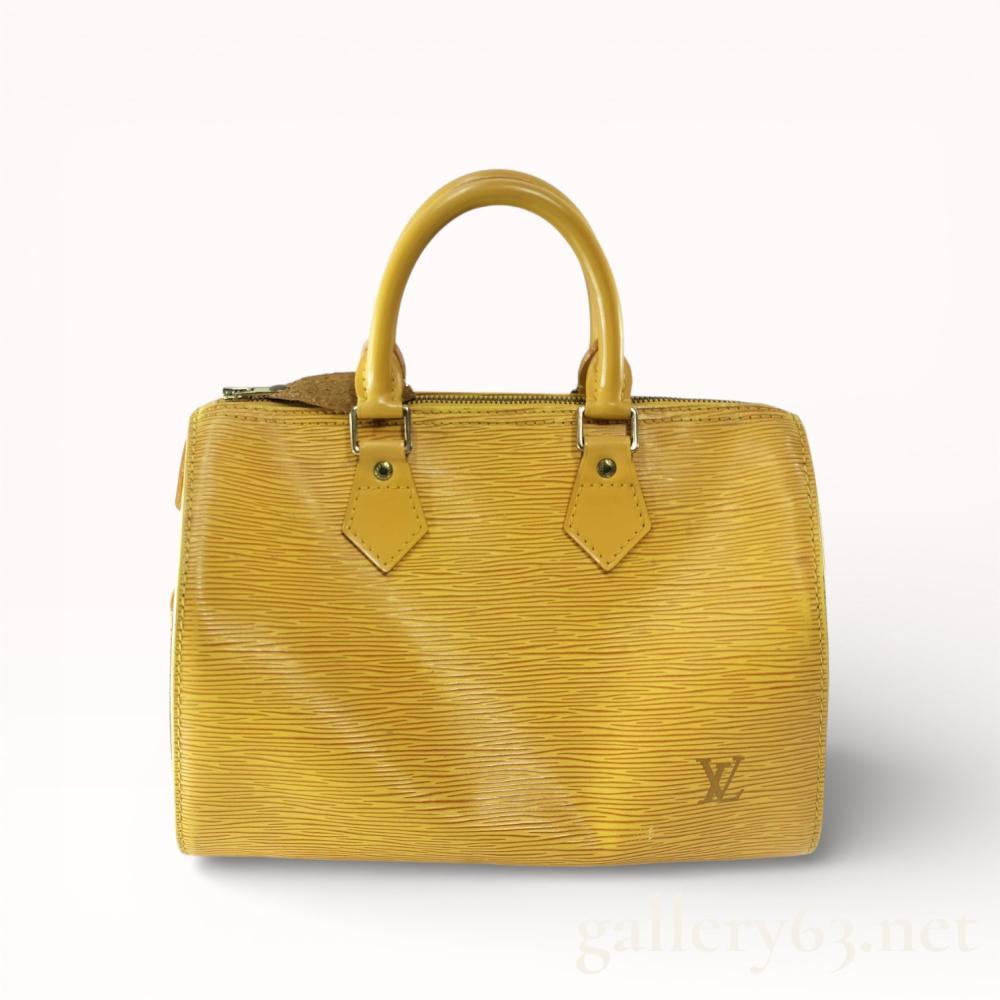 Description
Louis Vuitton Speedy 25 handbag crafted from Tassili Yellow textured Epi leather with a purple Alcantara-lined interior. The bag features rolled leather top handles, gold-tone brass hardware, a top zipper closure, and a single interior slip pocket. Exterior details include a debossed LV logo on the front corner and a side leather leaf heat-stamped with Louis Vuitton Paris made in France.
10 inches L x 7.5 inches H x 6 inches D.