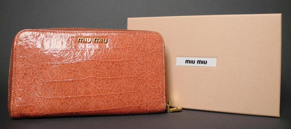 MIU MIU

Collection hiver 2011-2012 Portefeuille en cuir vernis vieux rose à imitation croco Fermeture zippée en métal doré L: 19 cm ETAT NEUF Dans sa boîte d’origine