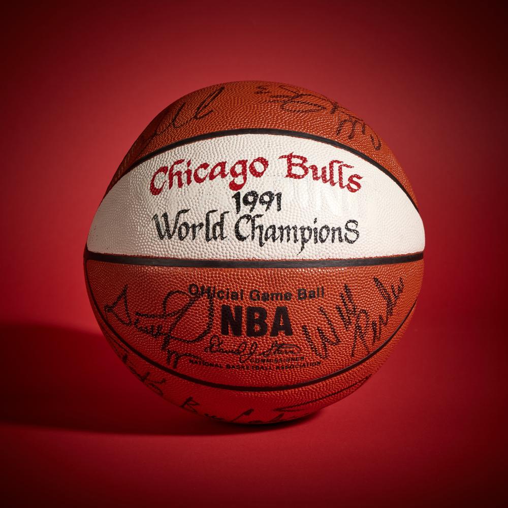 1991 Chicago Bulls ’World Champions’ Basketball | Signed by Michael Jordan, Scottie Pippen, and Others

SPALDING BASKETBALL

Circa 1991

Offered in this lot is a basketball signed by members of the 1990–1991 Chicago Bulls, painted with the inscription “Chicago Bulls 1991 World Champions.” This team captured the franchise’s first NBA championship and marked the beginning of one of the most successful dynasties in professional sports. After years of postseason setbacks, Chicago broke through with a 61–21 regular-season record, establishing itself as the league’s top team and signaling a shift in the NBA’s balance of power.

Led by Michael Jordan and Scottie Pippen, the Bulls entered the season focused on changing their narrative. Pippen had grown into a central figure, providing defense, playmaking, and versatility that allowed the team’s system to take hold under head coach Phil Jackson and his triangle offense.

Chicago’s playoff run concluded with a five-game victory over the Los Angeles Lakers in the NBA Finals, a series widely viewed as the passing of the torch from the Showtime era to a new generation led by the Bulls. Contributions from Horace Grant, John Paxson, and Bill Cartwright helped solidify a group that would define the decade.

Signed by members of this championship roster, the basketball includes autographs from Scottie Pippen, Michael Jordan, Dennis Hopson, John Paxson, B.J. Armstrong, Craig Hodges, Bill Cartwright, Will Perdue, Stacey King, Scott Williams, Cliff Levingston, and Horace Grant. The basketball comes directly from the Collection of Scottie Pippen.

The basketball is accompanied by a letter from James Spence Authentication in regards to the signatures.