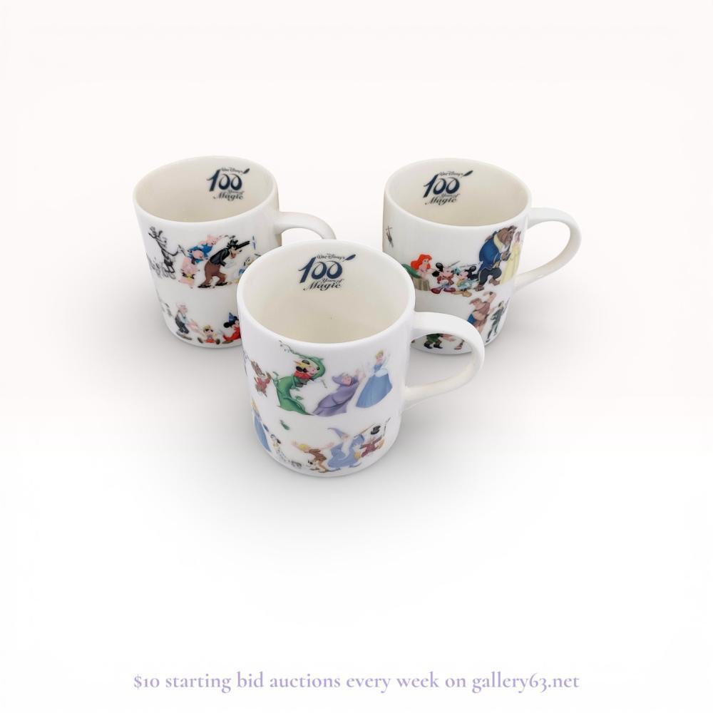 Description
A trio of Sango glazed white ceramic mugs produced for the Walt Disney’s 100 Years of Magic celebration, circa 2001. Each cylindrical mug features wrap-around transfer decorations of iconic Disney characters, including a design transitioning from grayscale to full color. The interior rims and bases are marked with the 100 Years of Magic logo and the Sango manufacturer stamp.
Height: 3.75 inches.