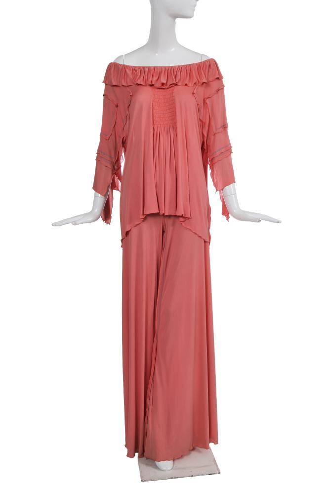 A Zandra Rhodes orange jersey rayon ensemble, 1974

A Zandra Rhodes orange jersey rayon ensemble, 1974

labelled, the top with shirred front and back panels, wide ruffle at neckline, the multi-layered sleeves with lettuce-edging and blue contrast stitching, bust 112cm 44in; the matching jersey trousers with elasticated waist, lettuce-edged hems, waist approx 76cm 30in (2)

Provenance: Lady Linda Vane Percy

Share this lot: