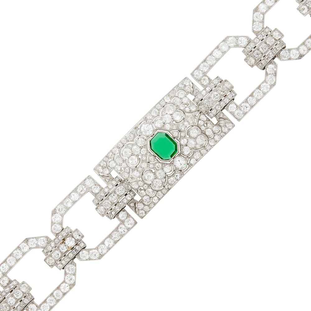 Property from a Prominent Maryland CollectionOne cut-cornered emerald-cut emerald ap. .95 ct., old-mine and single-cut diamonds ap. 17.00 cts., with maker’s marks, circa 1925, ap. 27 dwts. Length 7 inches.

Emerald: medium deep green, overall cleanish, small biotite flake on pavilion, lively.Diamonds: G-H-I-VS-SI.Nicely made. Width 7/8 inch.                             
Any condition statement is given as a courtesy to a client, is an opinion and should not be treated as a statement of fact and our Organization shall have no responsibility for any error or omission. Please contact the specialist department to request further information or additional images that may be available.