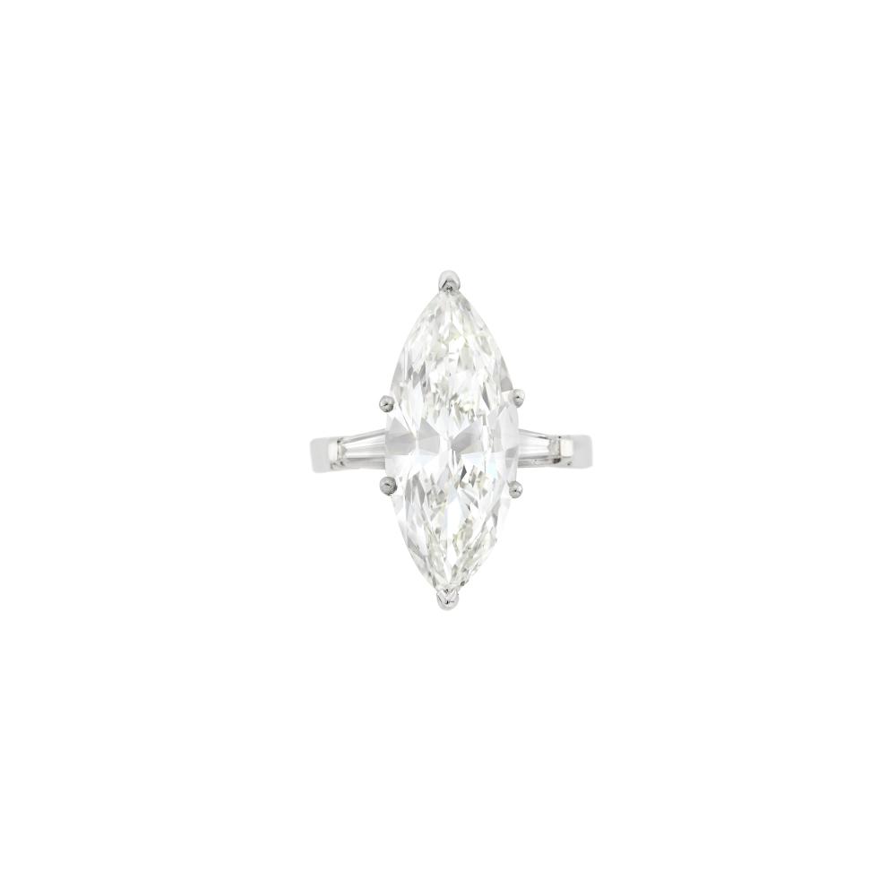 One marquise-shaped diamond weighing 7.54 cts., 2 tapered baguette diamonds. Size 7.
With GIA report no. 2155200586 stating K color, VVS2 clarity.

Diamond: K-VVS2, faint fluourescence.                            
Any condition statement is given as a courtesy to a client, is an opinion and should not be treated as a statement of fact and our Organization shall have no responsibility for any error or omission. Please contact the specialist department to request further information or additional images that may be available.