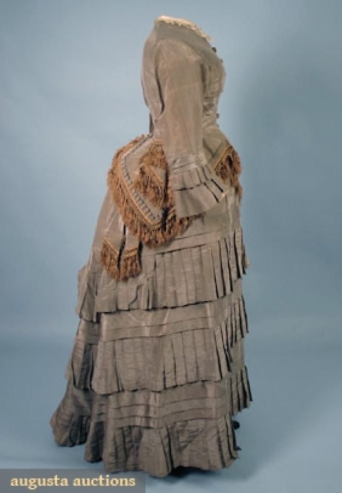 TAUPE SILK DAY DRESS, EARLY 1870s

2-piece shot silk, bodice w/ pleated self fabric trim & brown silk fringe, Dorset buttons, B 38", W 25", Front Skirt L 38", Back L 47", (brown foxing on fabric, 1 button missing, underarm stains) fair.		
Bid Online
Price Realized: $258.75Category:WomensEra:1850-1890
11.7263.114.783