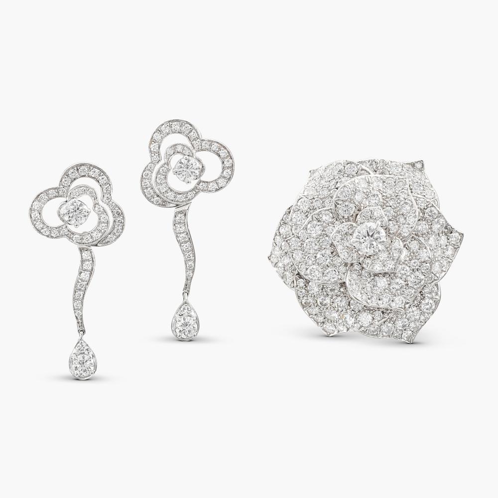 Piaget | Chanel

The ring designed as a rose, set with brilliant-cut diamonds, and a pair of earrings designed as stylised camellia motifs, set with brilliant-cut diamonds.
