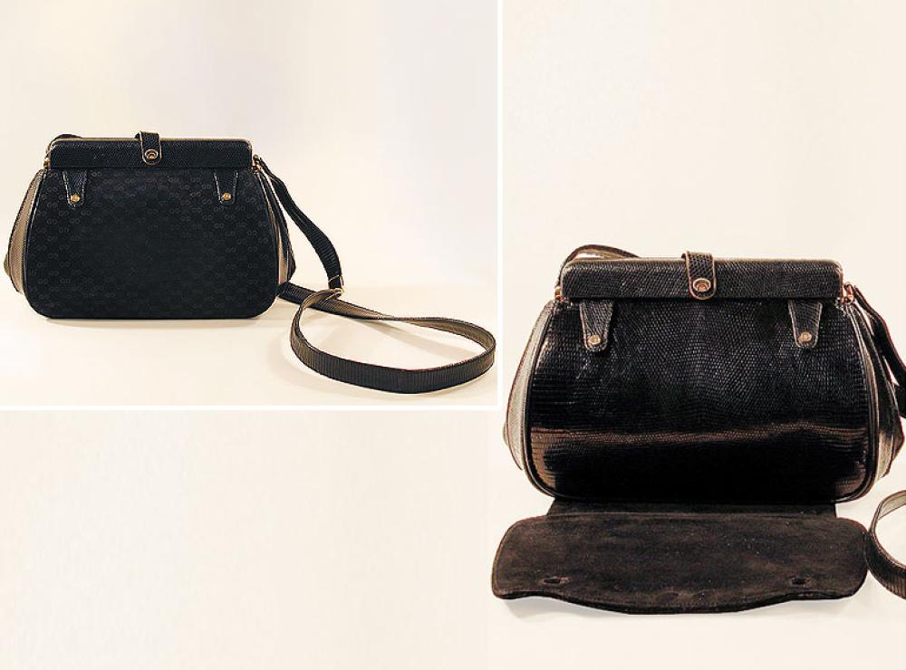 Gucci ’Two for One’ Handbag

Lot 872
Gucci ’Two for One’ Handbag
 Italian, 1960s 
 The black lizard rectangular pouch with rigid frame closure, gilt-metal hardware with en face G logo impressed, self strap optional long or short, with black suede snap-on cover with repeat logo pattern, 10 x 7 inches, labeled: Gucci/Italy. 
Excellent condition, some wear on suede.