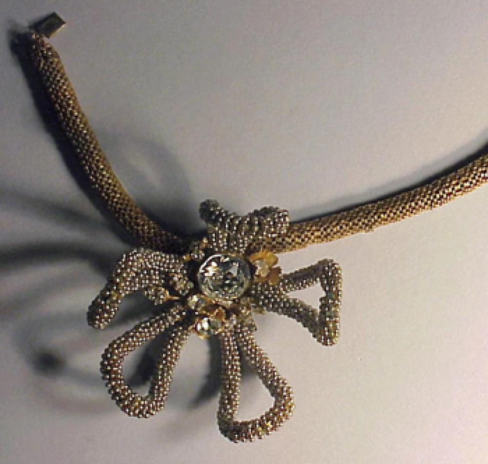 Miriam Haskell Anemone Necklace

Lot 249
Miriam Haskell Anemone Necklace
 The anemone ornament of seed pearls with white stone cluster center, set left of center on gilt-metal cord necklace, marked.
 See Cera, The Jewels of Miriam Haskell, p.46.