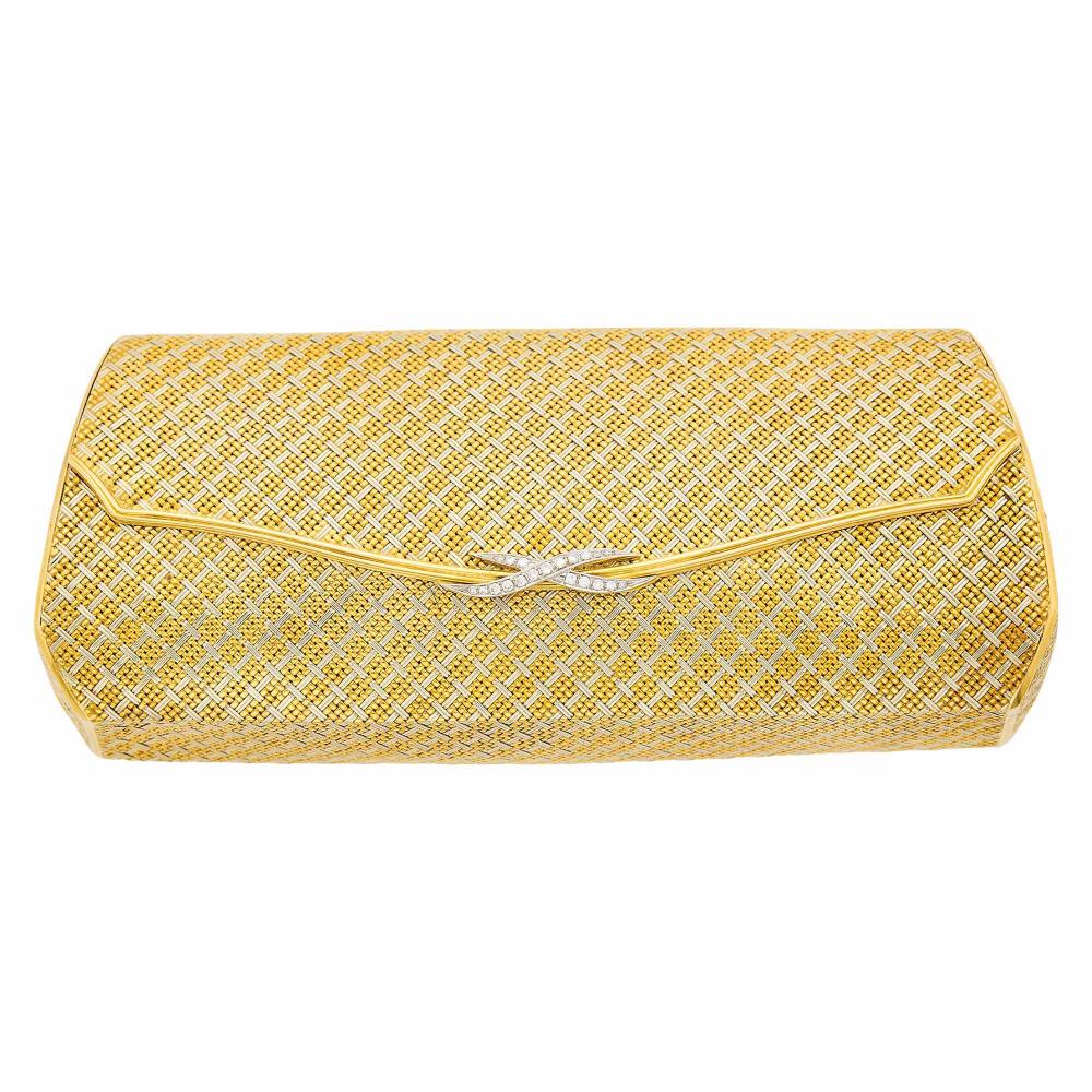 18 kt. yellow and white gold, 14 round and 6 single-cut diamonds ap. .65 ct., interior with mirror, ap. 229.5 dwts. gross. With fitted case. 7 1/2 x 3 1/8 x 1 5/8 inches.

Minor dent on left side of front under flap and on reverse, not easily noticeable.                            
Any condition statement is given as a courtesy to a client, is an opinion and should not be treated as a statement of fact and our Organization shall have no responsibility for any error or omission. Please contact the specialist department to request further information or additional images that may be available.