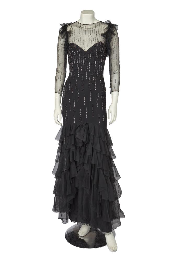A Loris Azzaro irridescent sequined black tulle evening gown, late 1970s

A Loris Azzaro irridescent sequined black tulle evening gown, late 1970s

labelled, with integral black silk slip, flounces of tulle to the front bodice sides, low back, tiers of tulle to the slightly trained hem, bust approx 81cm 32in, waist 61cm 24in

Share this lot: