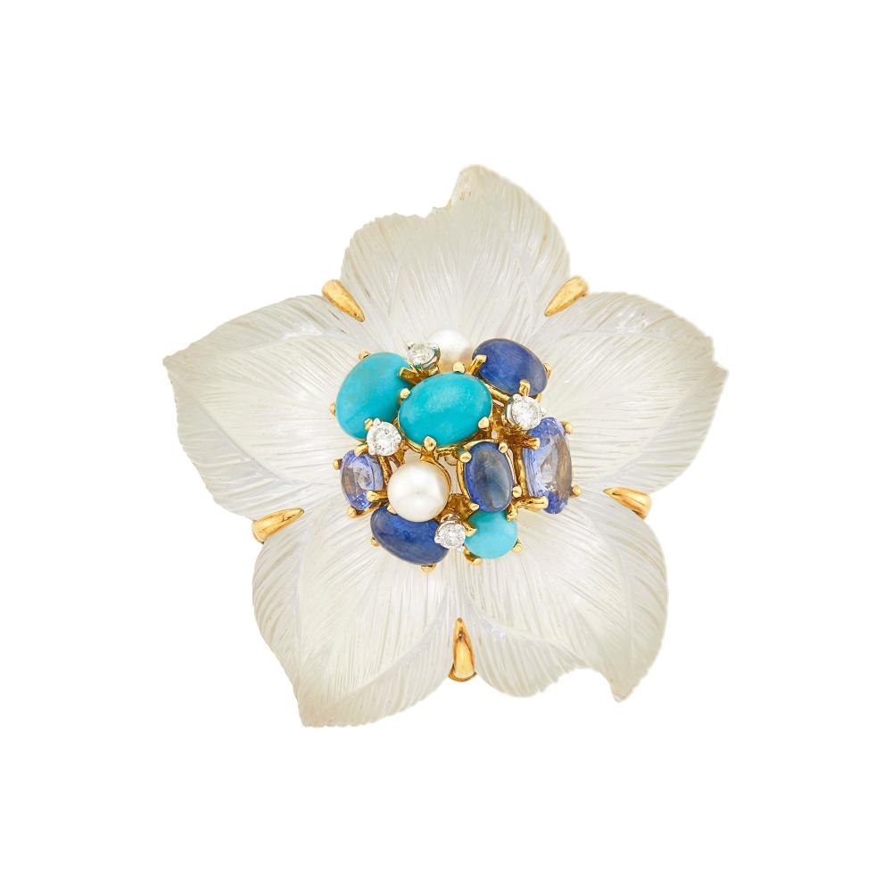 From the Estate of a Life-Long Upper East Side Woman18 kt., carved rock crystal petals, 3 round and oval cabochon turquoise, three oval cabochon sapphires, one round and one oval sapphires, two pearls, 4 round diamonds ap. .25 ct., signed Seaman Schepps, no. 10361, with maker’s mark,  ap. 25.8 dwts. gross.

Turquoise: deep turquoise blue, good luster.Cabochon sapphires: medium slightly violetish blue, moderately included, translucent, good polish.Sapphires: bright medium light pastel cornflower blue, slightly included, lively.Pearls: very slightly creamy with faint rose and green orient, cleanish, good luster.Diamonds: H-I-VS.2 x 2 inches.                            
Any condition statement is given as a courtesy to a client, is an opinion and should not be treated as a statement of fact and our Organization shall have no responsibility for any error or omission. Please contact the specialist department to request further information or additional images that may be available.