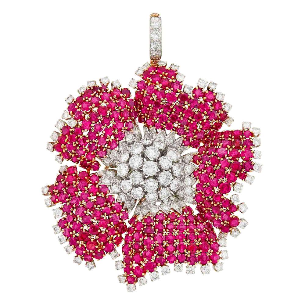 The Estate of a Private Collector18 kt., 19 round diamonds ap. 4.15 cts., 112 round diamonds ap. 5.35 cts., round rubies, signed Webb, one diamond missing, ap. 31.3 dwts.
 
With David Webb Certificate of Authenticity.

Diamonds: G-H-I-VS, one small diamond missing.Rubies: medium deep slightly pinkish raspberry, slightly to moderately included, lively.2 1/2 x 2 3/8 inches.                            
Any condition statement is given as a courtesy to a client, is an opinion and should not be treated as a statement of fact and our Organization shall have no responsibility for any error or omission. Please contact the specialist department to request further information or additional images that may be available.