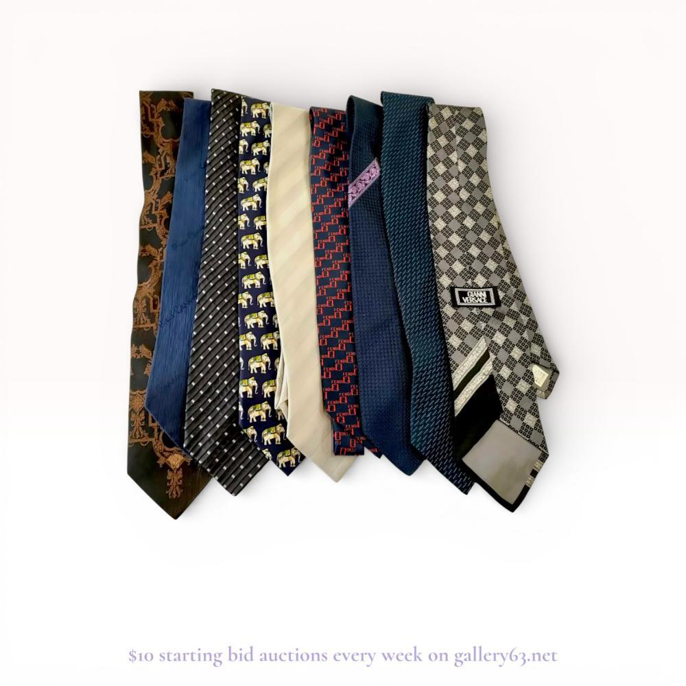 Description
A collection of nine designer neckties from designer houses including Versace, Fendi, Giorgio Armani, Dunhill, and Pierre Cardin. The assortment features various patterns including baroque filigree, logo grids, elephant motifs, and geometric stripes primarily executed in silk and silk blends. All items are Italian-made and include original manufacturer labels, keeper loops, and material tags.