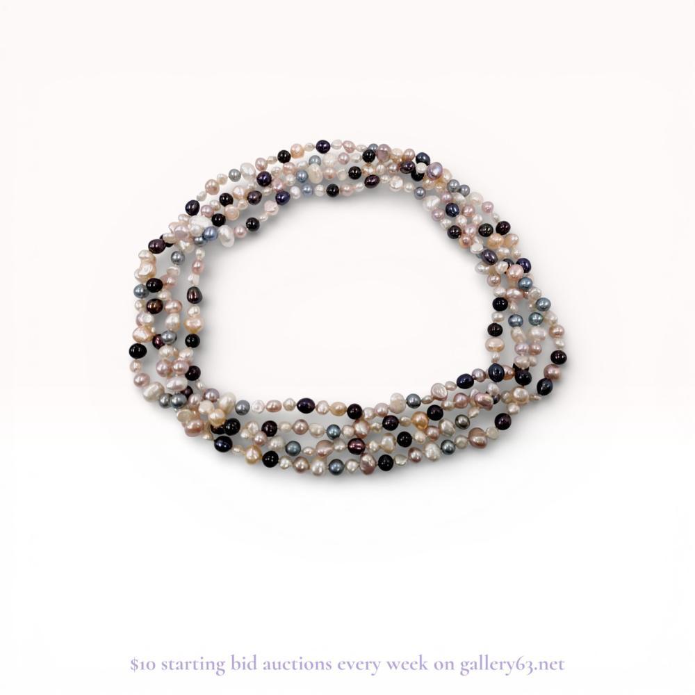 Description
A multi-strand necklace featuring four strands of baroque and potato-shaped cultured freshwater pearls in a multi-colored palette of white, peach, lavender, and peacock tones. The pearls are hand-knotted on thread in an endless, continuous strand design without a visible clasp. The organic shapes exhibit natural growth marks and characteristic surface irregularities.
Length: Approximately 16-17 inches per strand.