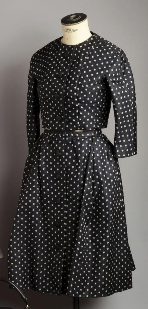 Christian DIOR, haute couture, n° 90958, Automne - Hiver 1957

Ensemble en faille noire à taches blanches, veste courte ras du cou, simple boutonnage manches longues raglan, jupe ample se boutonnant sur le devant. Griffe blanche, graphisme noir. Dernière collection de Monsieur Dior