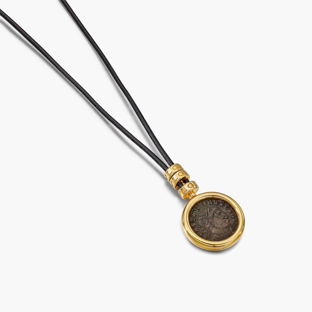 Bulgari

Suspending an ancient coin set in gold bezel depicting the profile of Constantine the Great, Sol Invictus the unconquered Romans sun god to the reverse, inscribed ’TREVIRI-CONSTANTINUS AUG. A.D. 307-337’, to the black cord, a later addition, composed of gold rondelles and caps.