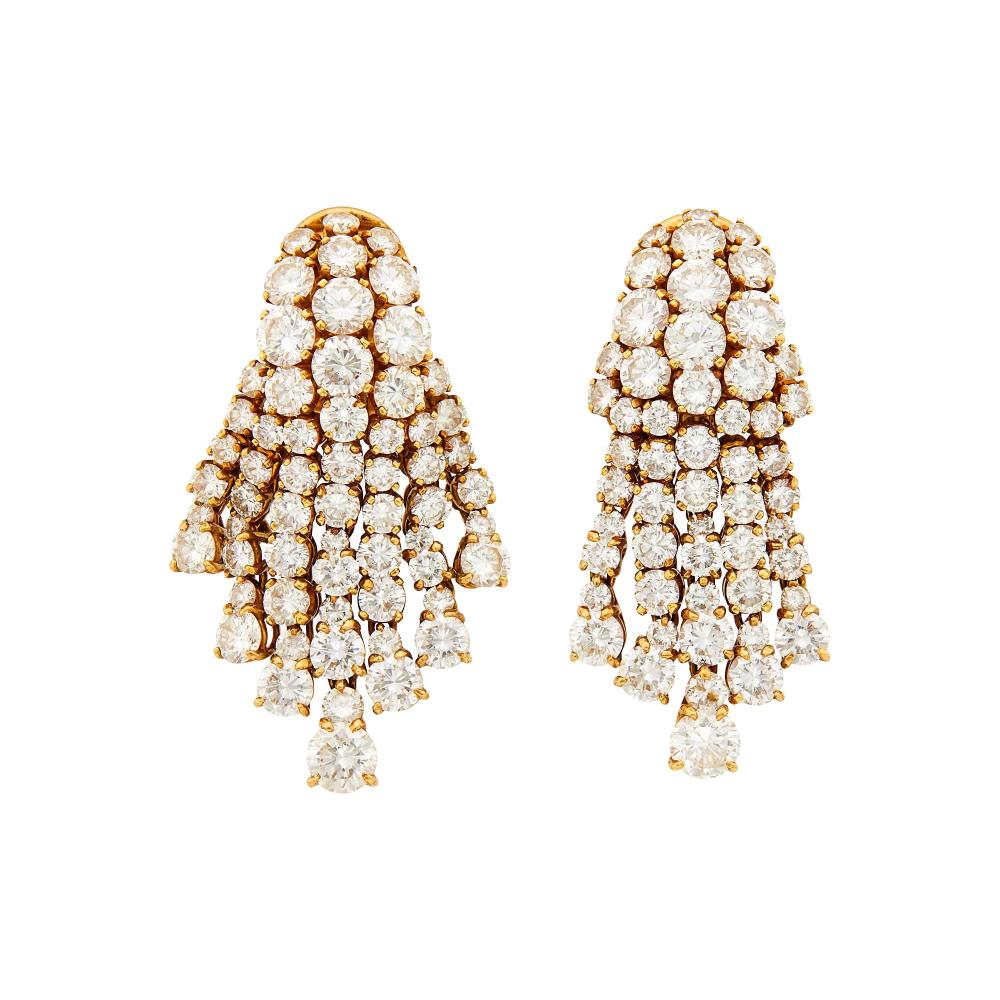 Property of a Distinguished Lady from Athens, Greece18 kt., 106 round diamonds ap. 14.35 cts., signed Vourakis, no. R73, ap. 17.2 dwts.

Diamonds: H-I-VS.Fringes move well.Nicely made. Clip-backs. 1 3/4 x 1 inches.                            
Any condition statement is given as a courtesy to a client, is an opinion and should not be treated as a statement of fact and our Organization shall have no responsibility for any error or omission. Please contact the specialist department to request further information or additional images that may be available.