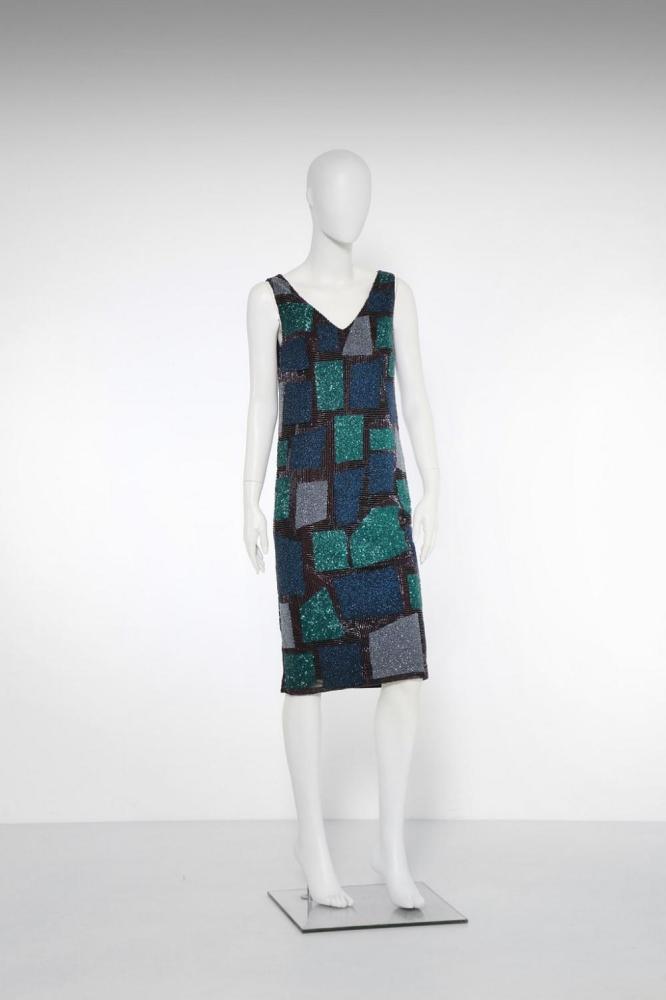 Description
SCHON MILA . Black embroidered dress.. Haute couture dress embroidered with beads in shades of green, blue and silver. Size 44.. Cm 43,00 x 107,00.

Artist or Maker
SCHON MILA