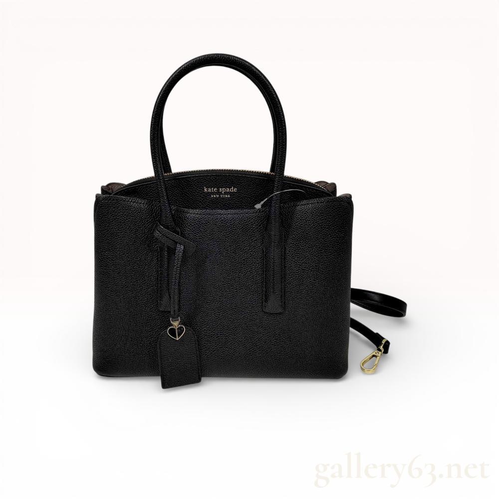 Description
A Kate Spade New York Margaux medium satchel crafted from black pebbled leather with gold-tone hardware. The design features dual rolled top handles and a detachable, adjustable shoulder strap. The front exterior is embossed with gold-tone lettering and includes a hanging leather tag with a signature spade charm. The bag is constructed with a triple-compartment interior, featuring a central zippered section flanked by two open side pockets. The interior is lined with a light-colored fabric patterned with spades and quatrefoils and contains one internal zip pocket. The base is fitted with four protective gold-tone metal feet.

Width: Approximately 11 inches