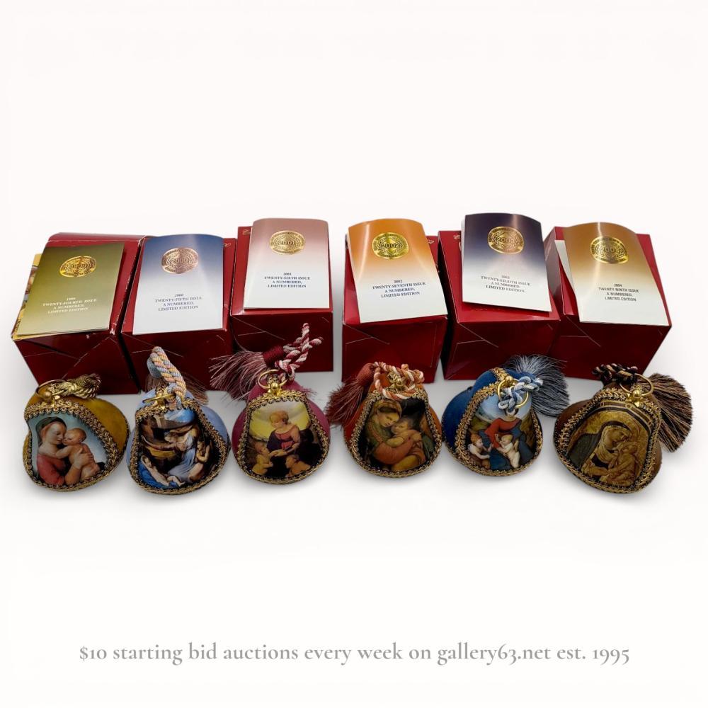 Description
Reuge Music Swiss Christmas Collector’s Bells, issues 24 through 29, dating from 1999 to 2004. Each bell features a fabric-covered body with gold-tone metallic braid trim, a coordinating tassel, and a central panel depicting a Madonna and Child painting. The underside houses a wind-up musical movement playing specific carols including O Tannenbaum and A Mighty Fortress Is Our God. Bases are marked with the manufacturer logo, issue year, song title, and individual production numbers.