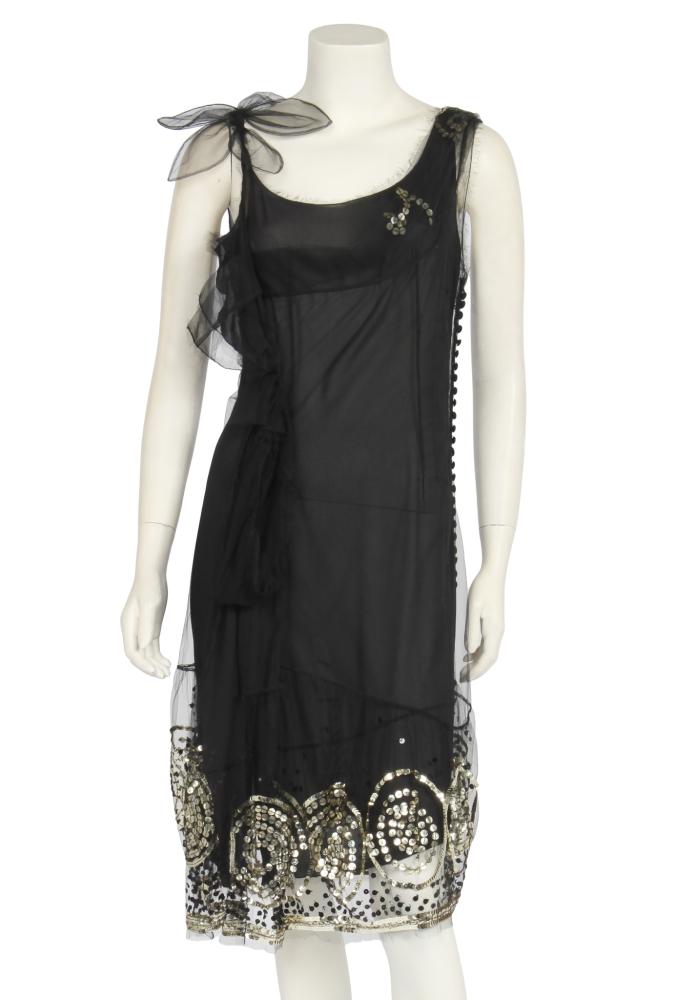 A John Galliano sequined tulle flapper-style dress, circa 2005

A John Galliano sequined tulle flapper-style dress, circa 2005

labelled, with integral chiffon underslip, the tulle over-dress with gilt sequined roundels to the hem, loops and bow to the side, tulle corsage to one shoulder, tiny buttons and loops decorative side detail, bust approx 86cm 34in

Share this lot: