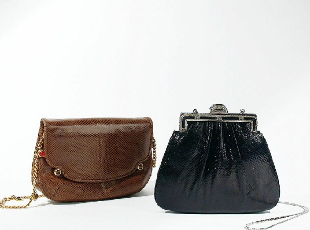 Two Judith Leiber Handbags

Lot 865
Two Judith Leiber Handbags
 The first of black karung pouched into frame and clasp ornamented with marcasite, silver metal drop-in chain, 7 1/2 x 6 inches; the second a rounded envelope of tan lizard, gilt-metal chain decorated with multicolored stones, 8 x 5 1/2 inches, both labeled: Judith Leiber.
Both excellent condition.