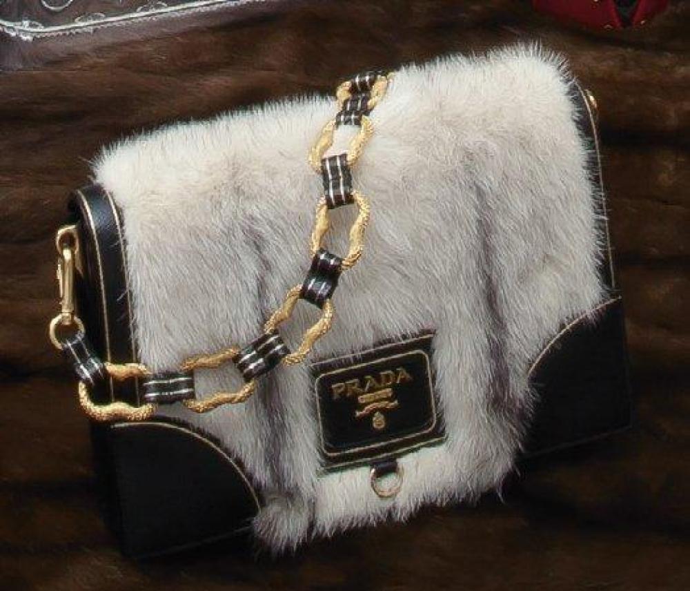 PRADA

Sac en cuir de Russie noir et vison Koïnor, surpiqûres or, fermoir aimanté sous rabat orné d’une plaque siglé de laiton doré, anse chaine amovible à maillons en métal gravé et cuir