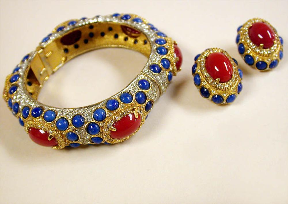 Kenneth Jay Lane Bracelet Suite

Lot 916
Kenneth Jay Lane Bracelet Suite
 American, mid 1960s 
 Comprising a gilt-metal hinged bracelet with diamante, lapis colored and red oval cabochons with matching clip earrings, marked: KJL.