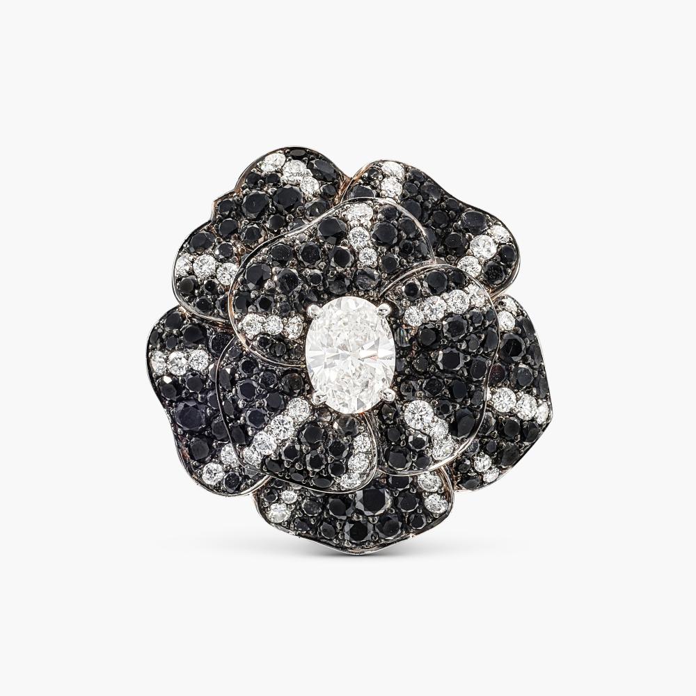 Chanel

Designed as a camellia, centring an oval diamond, the petals decorated with brilliant-cut diamonds and black diamonds.

Please note that the black diamonds have not been tested for natural colour origin.