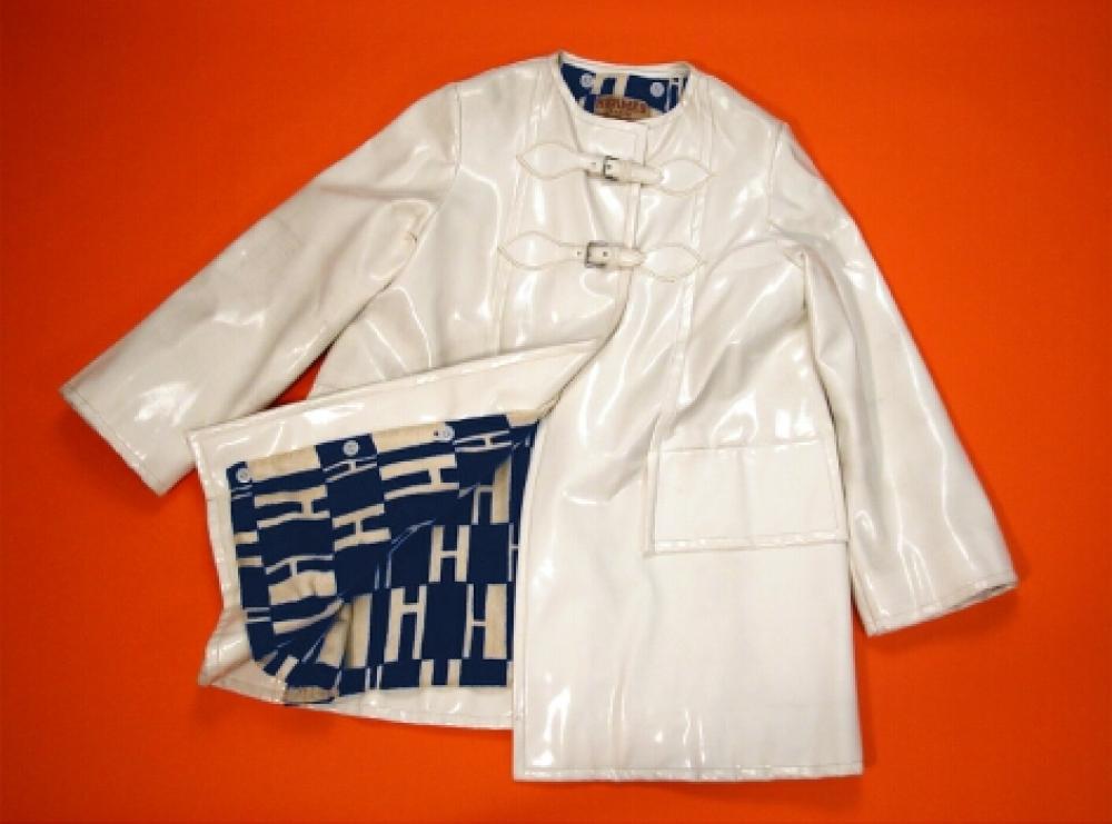 Hermes White Vinyl Coat

Lot 551
Hermes White Vinyl Coat
 French, 1960s 
 Three-quarter length, with large faux pocket flaps, straps and buckle closures, blue and white terry cloth logo removable lining, size 6-8, labeled: Hermes Boutique Sport.
Good condition, some marks on vinyl.
