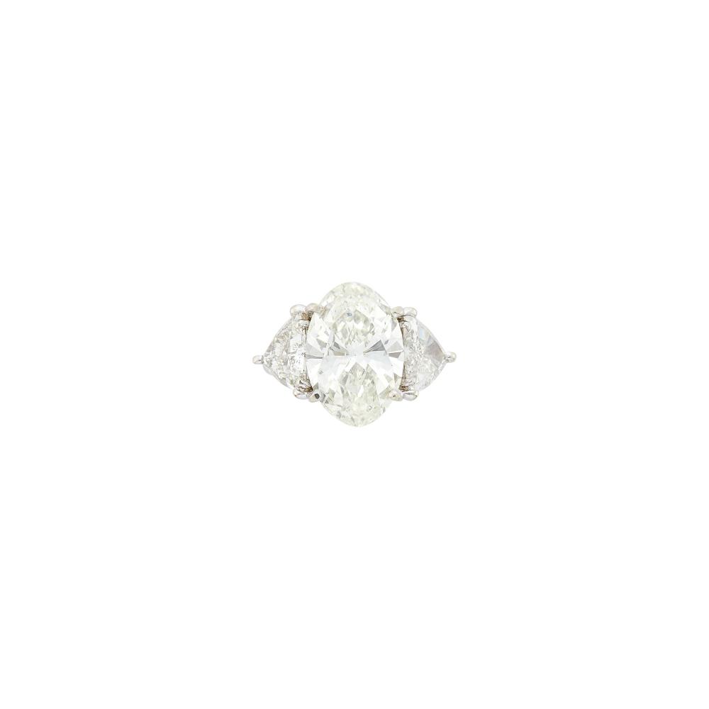 Property from the Collection of Augusta PattonOne oval modified brilliant diamond weighing 6.75 cts., 2 trilliant-cut diamonds ap. 3.00 cts. Size 6 3/4.
 
With GIA report no. 2231867270 stating L color, SI2 clarity.

Center diamond: L-SI2, no fluorescence.Side diamonds: H-I-J-I1                            
Any condition statement is given as a courtesy to a client, is an opinion and should not be treated as a statement of fact and our Organization shall have no responsibility for any error or omission. Please contact the specialist department to request further information or additional images that may be available.