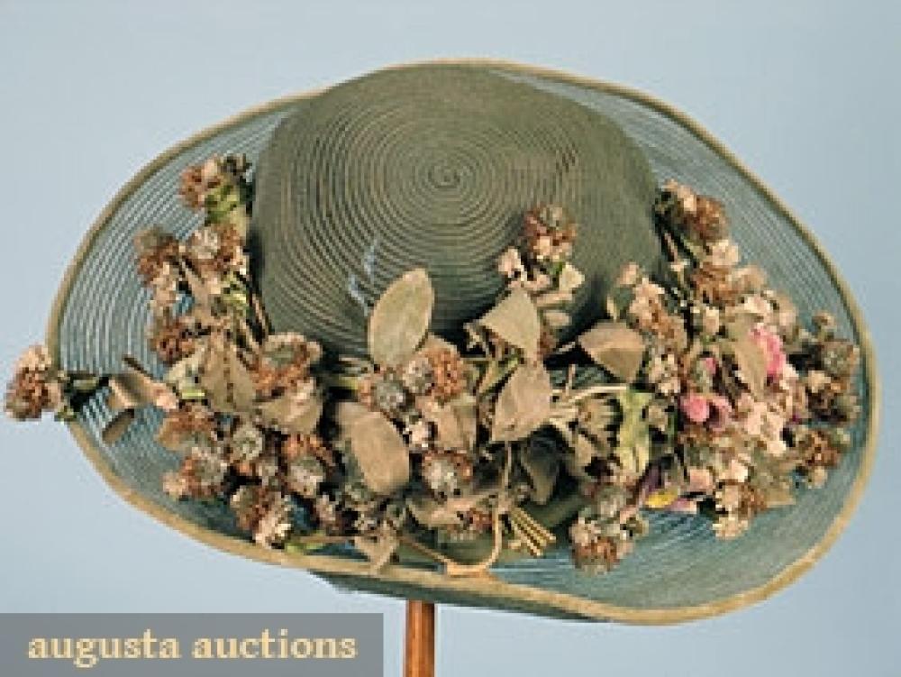 WIDE BRIM SUMMER CLOCHE, 1920s

Green horsehair w/ brown, green & pink cloth flower decoration, (silk lining shattered) good.		
Bid Online
Price Realized: $230.00Category:HatsEra:1890-1920
11.7528.630.455