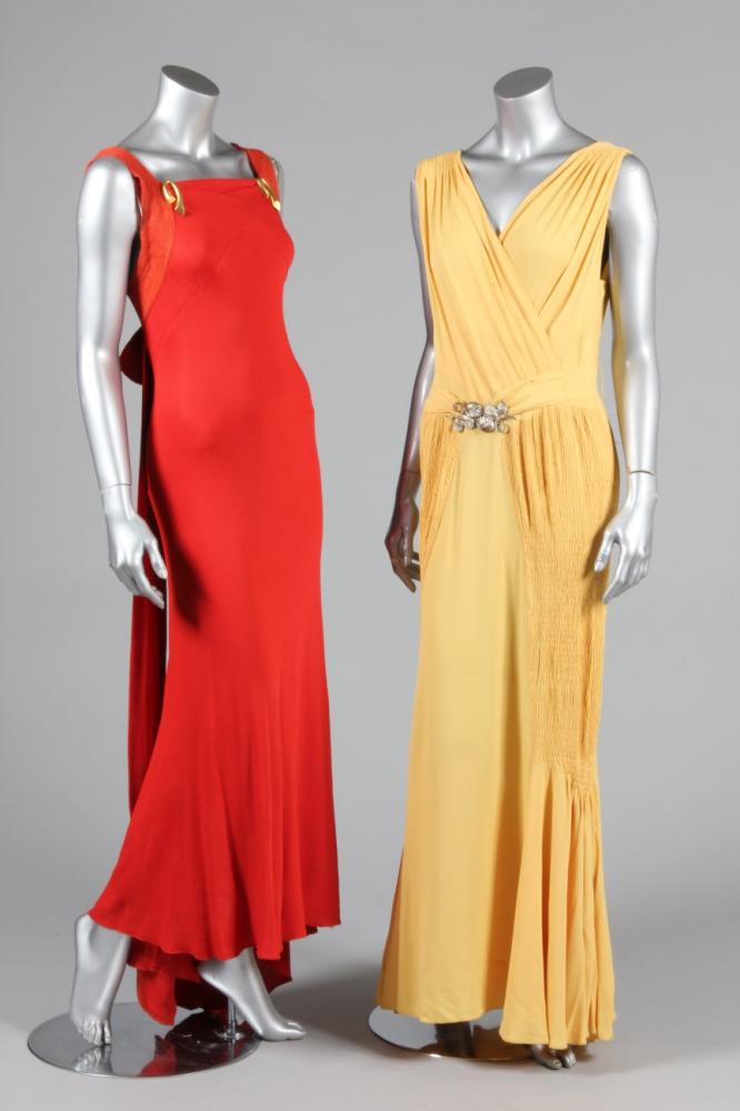 

Two silk crepe bias cut evening gowns, 1930s, one brick red with gilt metal curleques to the bodice, the other primrose yellow with shirred details to the skirt sides and metal belt cast with fruits and inset with rhinestones, busts 86-92cm, 34-36in (2)



Provenance: Henning Thorsen collectioni
