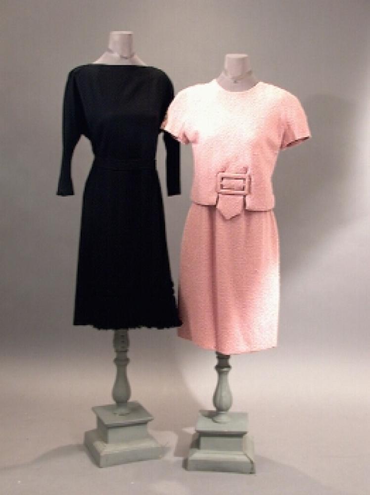 Two Balmain Late Day Dresses

Lot 532
Two Balmain Late Day Dresses
 French, mid 1960s 
 The first of black crepe with partial wrap front, hem trimmed with wool tassels, the next of pink mohair, comprising a blouse style bodice attached at front to a skirt sewn with silk underbodice, self large front buckle, with small skullcap chapeau, each size 6, each labeled: Pierre Balmain/Paris, tape label no.: 773793 on second. 
Each very good condition.