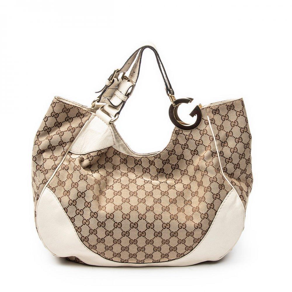Description

GUCCI
Charlotte Hobo bag.
In monogram canvas with ivory leather details. Gold-tone metal hardware. Double top handle adjustable by buckle. Interior lined in fabric.
With interior numbering.
Very good condition, with normal signs of use.
Measurements: 40 x 35 x 17 cm.

The Gucci Charlotte Hobo is inspired by the traditional codes of the Italian firm: high quality leathers, refined lines and discreet details that show the Florentine craftsmanship. The Charlotte Hobo takes up the tradition of Gucci hobo bags, popular since the 1970s for their relaxed, roomy and adaptable silhouette.

With interior numbering. Very good condition, with normal signs of use.