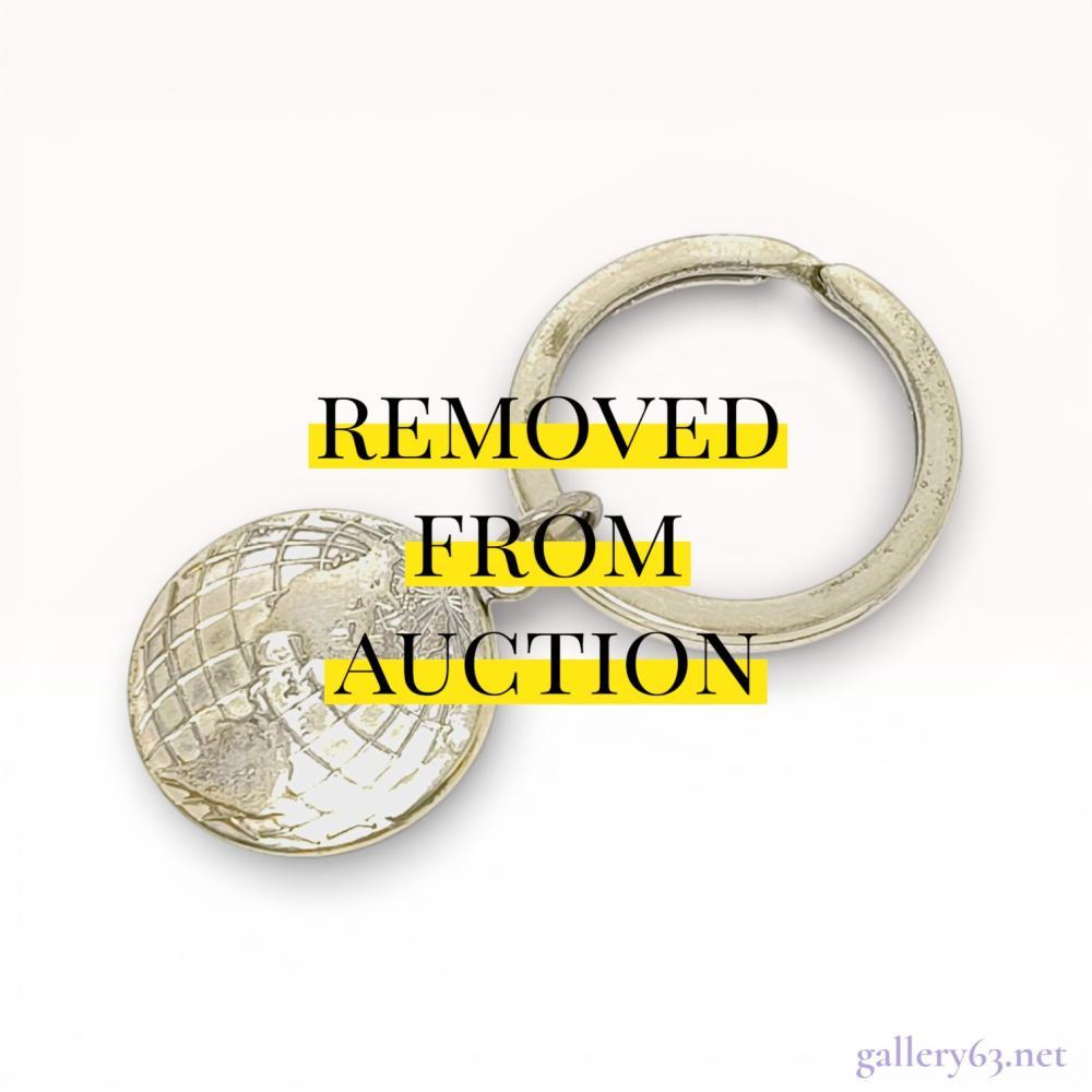Description

This authentic Tiffany & Co. keyring is constructed from .925 sterling silver and features a circular charm with a raised, embossed world globe motif on the obverse. The split-ring is stamped TIFFANY & CO. 925, and the reverse of the charm is marked © 2000 TIFFANY & CO. 925. The reverse of the charm also features a large, partially obscured engraving of the initials ABC. This lot is complete with its original signature Tiffany Blue presentation box and a branded drawstring fabric pouch. Total length measures approximately 5.5 cm with a ring diameter of approximately 3 cm.





The Tiffany & Co. sterling silver World Globe Keyring from circa 2000 with its box is a piece from the house’s most internationally ambitious small accessories period - the globe motif, representing travel, exploration, and global connection, is a design that has been consistently popular among Tiffany collectors. A boxed circa-2000 Tiffany globe keyring represents not just a functional object but a documented moment in the house’s design history.