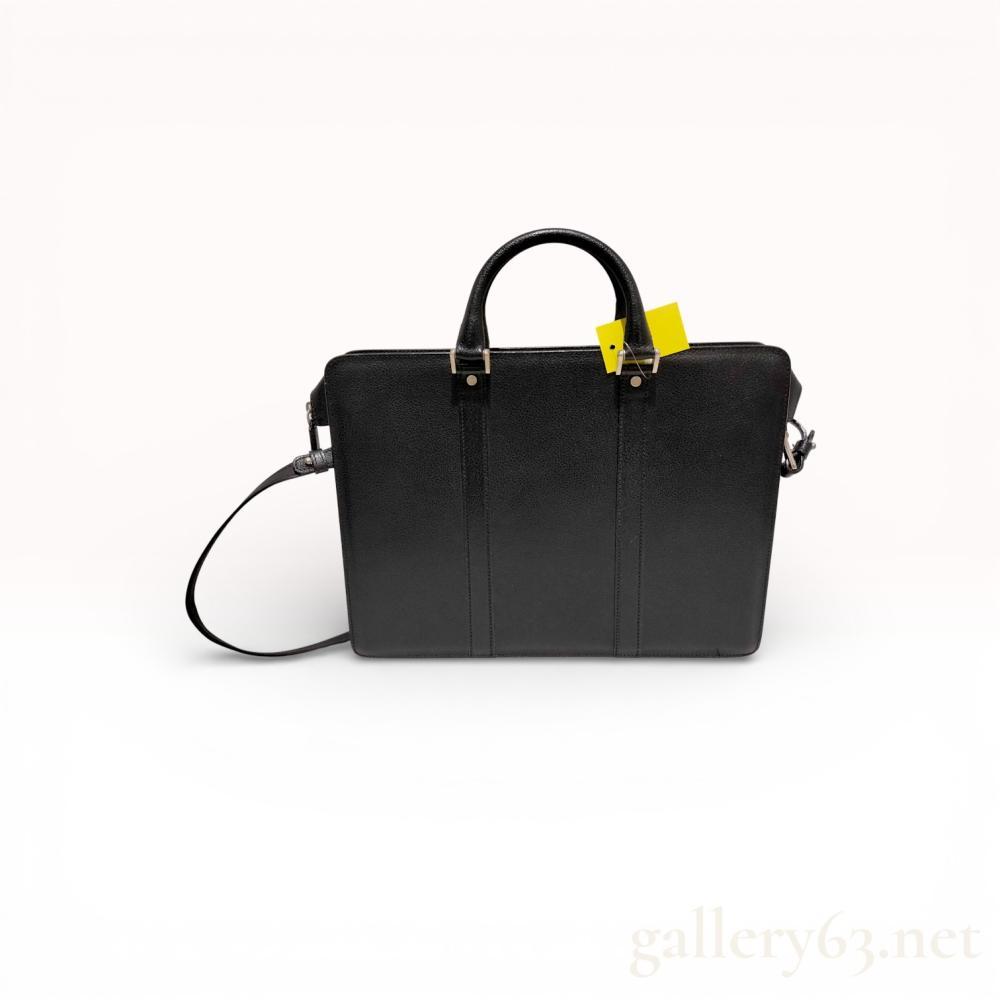 Description
Authentic Salvatore Ferragamo leather business bag having a structured silhouette featuring rolled leather handles, a detachable shoulder strap, and silver-tone hardware. Exterior leather featuring light rubbing at corners and minor surface marks. Handles featuring light creasing. Interior featuring a fabric lining with zipper and open pockets showing light wear. Zippers and hardware functioning properly.