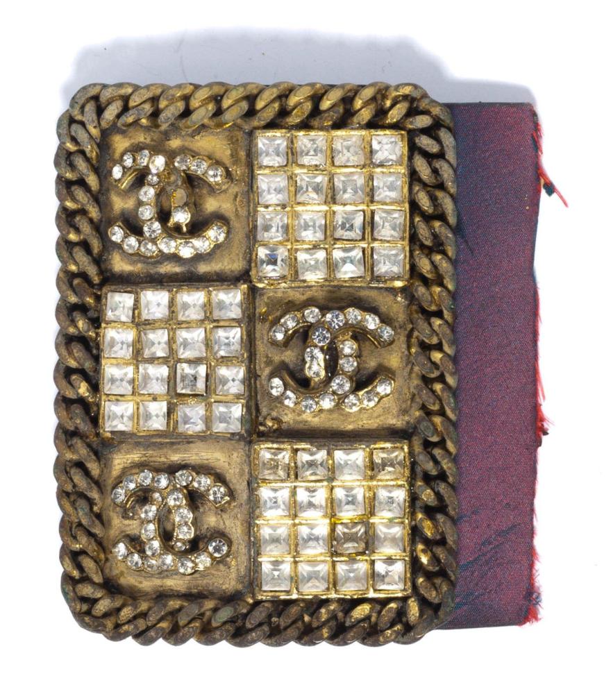 CHANEL

Haute coutureBoucle de ceinture de forme rectangulaire en métal doré serti d’une chaîne ornée de strass calibrés et de sigles (en l’état)