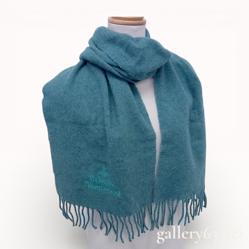 Description
Vivienne Westwood wool scarf in a solid teal blue color. The item is constructed from 100% wool and features a tonal embroidered orb logo with the brand name on the lower front. It is finished with twisted fringe trim at both ends and includes the original woven designer and care labels.