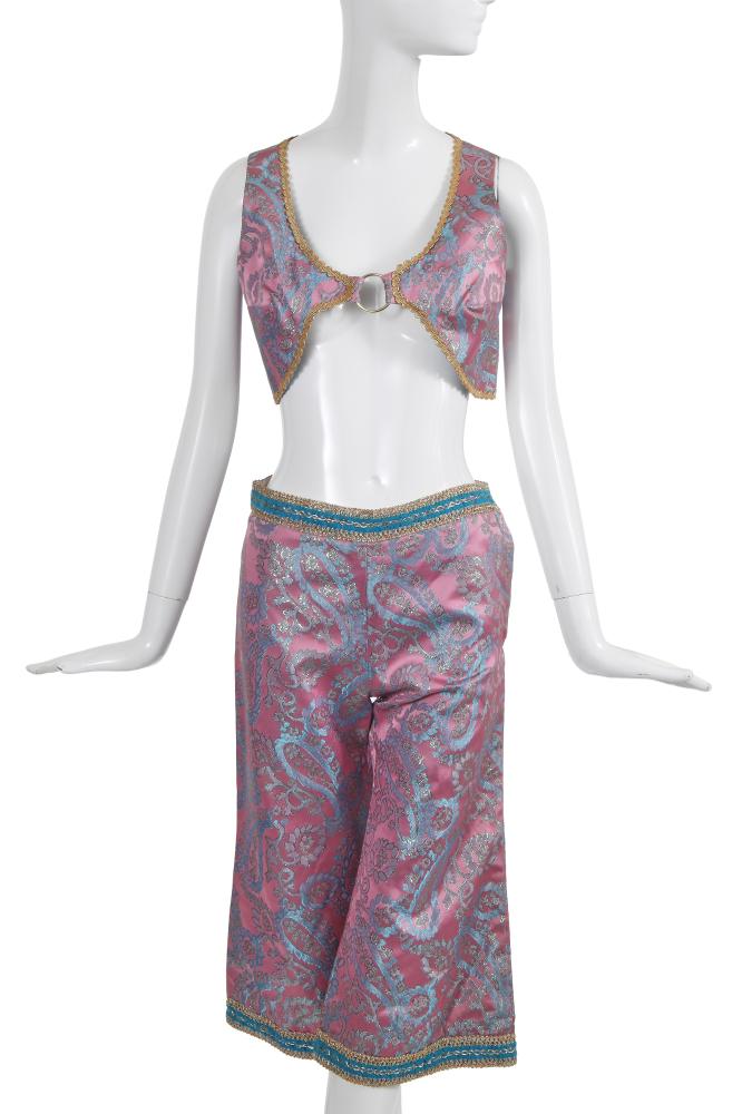 A rare Beatles’ Apple boutique ensemble, 1967-68

A rare Beatles’ Apple boutique ensemble, 1967-68

woven apple logo label, of pink and blue brocade woven with silver lamé patterns, the cropped V-neck vest/top with silver ring to the centre, trimmed with gold gimp trim, bust 91cm 36in; the matching cropped wide-legged trousers with blue and gold trim, waist 71cm 28in (2)

The Apple boutique opened on 94 Baker Street in December 1967 and closed just 7 months later in July 1968, having lost more than £100,000 in trading during that time. The night before the shop closed, the Beatles selected pieces for themselves to wear and the next morning opened the doors to crowds massing outside and, in true hippie spirit, told the waiting public to just help themselves to the rest. Paul McCartney said of it: ’The nice thing was that we weren’t too fussed when it didn’t work out [...] It was great: giving the clothes to people who showed up on the day’ (The Beatles Anthology, Cassell & Co, 2000, p.296).

Share this lot: